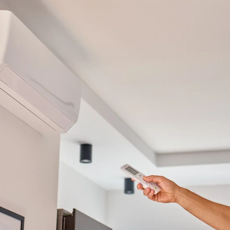 hand-using-remote-control-to-adjust-temperature-on-2025-08-10-22-30-45-utc-petite